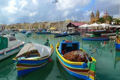 several colorful boats are docked in the water