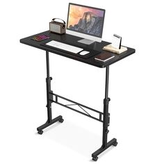 a computer desk with a laptop on it