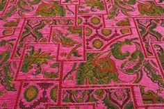 an intricately designed pink and green carpet