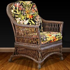 a wicker chair sitting on top of a hard wood floor next to a wall