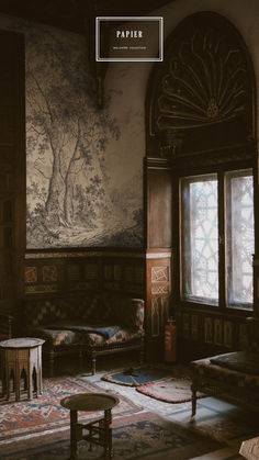 the interior of an old house with paintings on the wall and furniture in the room