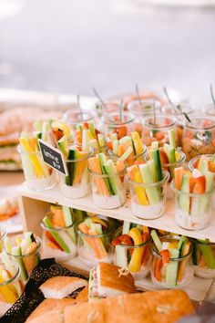 many small cups filled with different types of food