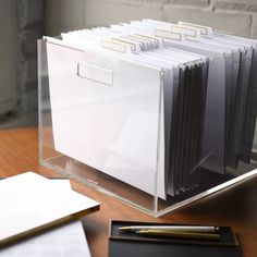 a stack of folders sitting on top of a wooden table