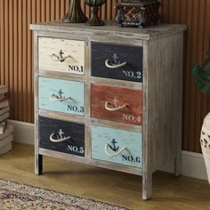 an old dresser with many drawers painted in different colors