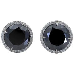 A versatile piece of jewelry that goes well with any outfit. Features two round black diamonds set in a brilliant diamond halo basket made in 18k white gold. Black diamonds weigh 17.88 carats total. 0.65 inches in diameter. Luxury Jewelry With Round Cut Black Diamonds, Formal Round Black Diamond Earrings, Formal Black Diamond Round Earrings, Black Diamond Earrings For Wedding, Luxury Round Black Diamond Earrings, Luxury Black Diamond Round Earrings, Luxury Black Diamond Round Jewelry, Black Diamond Jewelry With Brilliant Cut, Black Platinum Jewelry With Diamond Accents