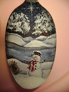 a painted snowman hanging from the side of a wall