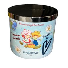 a small tin container with an image of two children on the front and one in the back