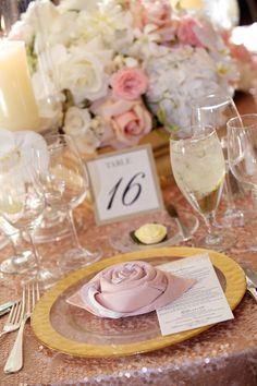 the table is set with champagne and flowers