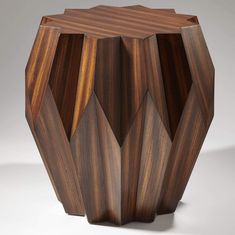 a wooden vase is shown on a white surface and it looks like hexagonal shapes