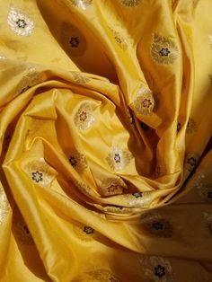 an image of a yellow cloth with flowers on it