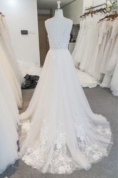 a white wedding dress on display in a store