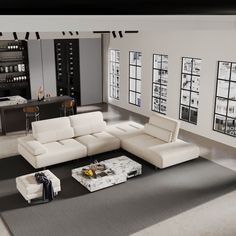 a modern living room with white leather furniture