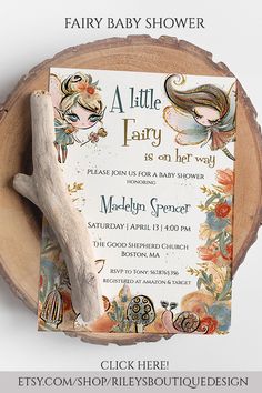 a baby shower is on display in front of a wood slice with an angel and flower design