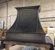 a large black stove top sitting inside of a kitchen next to a wall mounted oven