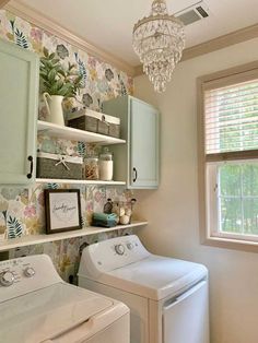 a washer and dryer in a room with floral wallpaper on the walls