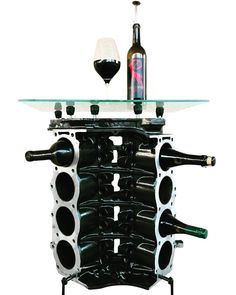 a wine rack with bottles and glasses sitting on it's side, in front of a white background