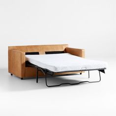 a couch with a pull out bed on it's back and one arm extended