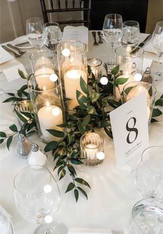 the table is set with candles and place cards