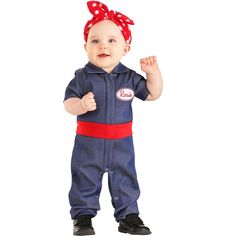 a baby girl wearing a blue and red outfit with a polka dot bow on it's head