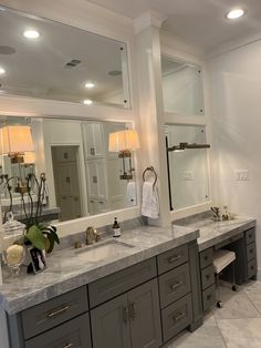 a large bathroom with two sinks and mirrors