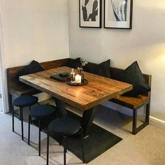 a wooden table sitting next to two black chairs