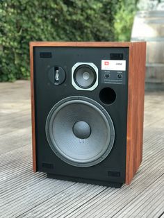 a speaker sitting on top of a wooden table