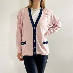 Smart, classy vintage ladies cardigan in pastel pink and navy trim. It has a straight, boxy shape with shoulder pads, v-neck collar and front pockets. Very warm, but lightweight. Perfect over a T-shirt or a smart blouse. Made in Hong Kong by Reldan. 70% acrylic, 30% wool. Large size, labelled as 80's Medium. Measurements when laid flat are: Pit to pit: 60cm Waist: 59cm Hemline: 56cm Length: 68cm Excellent condition. Pink V-neck Cardigan For Work, Pink Long Sleeve Relaxed Fit Cardigan, Pink Long Sleeve Retro Cardigan, Pink Button-up Cotton Cardigan, Vintage Pink Cardigan With Buttons, Navy Cardigan, Gilet Long, Rose Pastel, Neck Collar