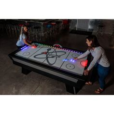 two women playing an interactive game on a table