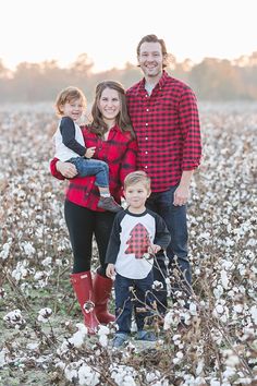 a family standing in a cotton field