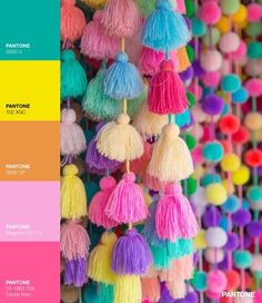 the color scheme is pantone's pink, yellow and green with pom - poms