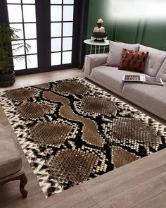 a living room area with a couch, chair and rug on the floor in front of a window