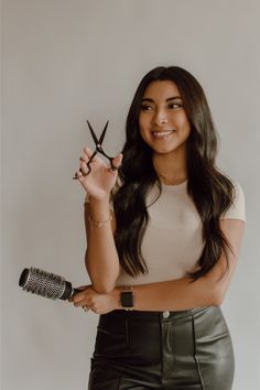 a woman holding scissors in her right hand