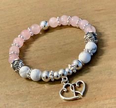 The Love Hearts Stretch Stacking Bracelet is crafted with 8mm Genuine Rose Quartz, 8mm Natural Howlite Stones, 8mm Natural Gray Jasper Stones, 6 & 8mm silver plated beads & silver plated Bali-style spacer beads adorned with silver plated hearts charm on strong stretch cord. Each bracelet is custom hand crafted by me... I use high quality stones, beads & findings to create unique one of a kind pieces you'll enjoy gifting & wearing for years. Please select a size on the drop down menu. If you need a different size please send me a message at check out. ✭ Due to the nature of handmade, natural gemstones and computer screens your jewelry is subject to slight color variations. Bali Style, Howlite Stone, Bali Fashion, Love Hearts, Jasper Stone, Bracelet Stack, Stretch Bracelet, Spacer Beads, Stretch Bracelets