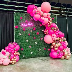 pink balloons and streamers decorate the backdrop for a party at a corporate function venue