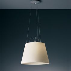 a white lamp hanging from a ceiling in a room with dark walls and flooring