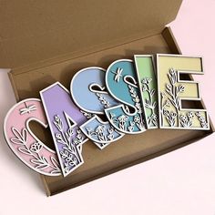 an open box with some cut out letters in it