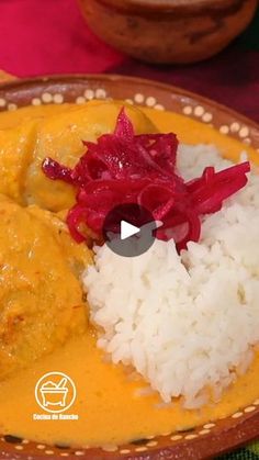 a plate with rice, meat and vegetables on it next to a bowl full of other food