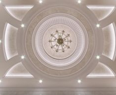 an overhead view of a ceiling in a building with lights on the ceiling and around it is a circular chandelier