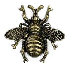 a gold and black bee broochle on a white background