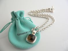 Overview:Offered for sale is a wonderful, very rare and gorgeous Tiffany & Co. Silver & Large Smoky Quartz Gemtone Toggle necklace. Definitely a Tiffany piece that you will get your money's value for. It works perfectly with pretty much any attire your put on, AND is an awesome statement piece. It is the perfect necklace that fits a lifestyle on the go -- the piece can be worn to pretty much any occasion! It is simple, elegant, and classic all rolled into one. Imagine wearing the piece with your Designer Polished Finish Necklace Gift, Timeless Jewelry Gift, Designer Sterling Silver Necklace Gift, Designer Sterling Silver Necklace For Gift, Designer Hallmarked Jewelry For Collectors, Designer Engraved Necklace For Gift, Designer Engraved Rectangular Jewelry, Luxury Sterling Silver Rectangular Necklace, Luxury Rectangular Sterling Silver Necklace