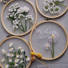 four embroidery hoops with flowers in them