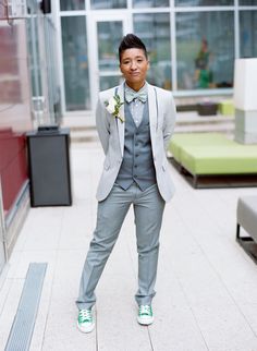 a man in a gray suit and green shoes