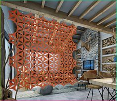 a living room filled with lots of furniture and walls covered in orange laser cut paper