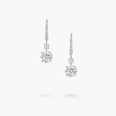 The Classic Graff collection presents eternally elegant diamond jewellery, including these drop earrings. Two precisely matched round diamonds, are suspended from two smaller round stones. Selected for their exceptional purity and fire, they are complemented by slender swan hooks embellished with gently graduated pavé diamonds. Exquisitely crafted to accentuate the brilliant beauty of the round diamonds, these sleek and timeless earrings are designed to be cherished for a lifetime. Graff Jewelry, Diamond Shaped Engagement Ring, Graff Diamonds, Round Diamond Earrings, Diamond Solitaire Earrings, High Jewellery, Fine Diamond Jewelry, Solitaire Earrings, Engagement Ring Shapes