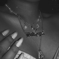 a woman wearing a necklace with the word lovebirds written on it in black and white