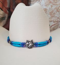 Western Horse and Horseshoe Hat Band - Silver metal horse with horseshoe centerpiece or cowgirl and horseshoe centerpiece - Western Cowboy Turquoise Bone Hairpipe Bead Hat Band with blue accent beads.  Includes deerskin adjustable tie in back.  Measures approximately 23" in length.  Shown on a size 7 cowboy hat. Hat is not included.  Want a different color (just ask)! See my other hatbands:   https://www.etsy.com/shop/BlueEyesDesignsHB?ref=shop-header-name&listing_id=1476946144&section_id=31618272 See Custom Hat Band Listing:  https://www.etsy.com/listing/1239791038/custom-western-cowboy-cowgirl-hat-band?click_key=a8f27a46910e80585f9a75cc01cce729f063234b%3A1239791038&click_sum=98b927d5&ref=shop_home_active_8&sca=1&sts=1 You can add decorative beads and feathers to any hatband  -  Just clic Mexican Quinceanera Dresses, Cowboy Hat Bands, Hair Keepsake, Beaded Hat Bands, Boot Bracelet, Western Cowboy Hats, Beaded Hat, Decorative Beads, Deer Skin