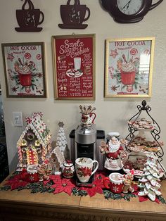 there are many christmas decorations on the table with coffee cups and mugs in front of them