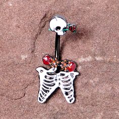 Black Skeleton Skull Rose Halloween Double Mount Belly Ring Start your Halloween or goth girl shopping with this monster-inspired 14 gauge navel jewelry that has scary style. Made with a 3/8" black PVD over 316L surgical grade stainless steel curved barbell, this navel piercing features a skull top charm with a rose through its eye and a skeleton's ribcage bottom charm that also has roses too!Specifications14 Gauge (1.6mm), 3/8" (10mm), Black PVD over 316L Surgical Grade Stainless Steel Curved B Adjustable Metal Body Jewelry For Halloween, Halloween Silver Body Jewelry Gift, Gothic Adjustable Body Jewelry For Halloween, Silver Body Jewelry For Halloween, Adjustable Gothic Body Jewelry For Halloween, Halloween Skull Jewelry In Bone Color, Cheap Gothic Metal Belly Rings, Black Jewelry For Day Of The Dead Gift, Halloween Skull Shaped Bone Jewelry