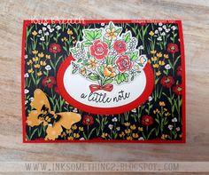 a close up of a card with flowers on it and a butterfly in the background