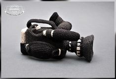 a knitted toy camera is shown on a gray background with the words, crochet photography written below it